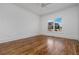 Bright bedroom with hardwood floors, a ceiling fan, and large window with natural light at 1304 Marietta Country Club Nw Dr, Kennesaw, GA 30152