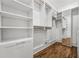 Well-organized closet with built-in shelves and hanging rods for optimal storage at 1304 Marietta Country Club Nw Dr, Kennesaw, GA 30152