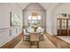 Bright dining room with hardwood floors, wainscotting and large windows providing lots of natural light at 1304 Marietta Country Club Nw Dr, Kennesaw, GA 30152