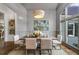 Cozy dining room with natural light, neutral color palette, and a large window with window seat overlooking the backyard at 1304 Marietta Country Club Nw Dr, Kennesaw, GA 30152
