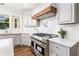 Contemporary kitchen with stainless steel oven, white marble backsplash and countertops at 1304 Marietta Country Club Nw Dr, Kennesaw, GA 30152