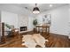 Bright home office featuring hardwood floors, a cozy fireplace, and a stylish desk at 1304 Marietta Country Club Nw Dr, Kennesaw, GA 30152