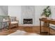 Elegant office space with a marble fireplace, hardwood floors, and a comfortable seating area at 1304 Marietta Country Club Nw Dr, Kennesaw, GA 30152