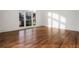 Sunlit room featuring hardwood floors, large windows, and a bright, airy ambiance at 1304 Marietta Country Club Nw Dr, Kennesaw, GA 30152