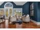 Charming sitting area featuring French doors, hardwood floors, and stylish furnishings at 1304 Marietta Country Club Nw Dr, Kennesaw, GA 30152