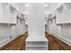 Spacious walk-in closet offers ample storage, custom shelving, and wood flooring at 1304 Marietta Country Club Nw Dr, Kennesaw, GA 30152