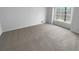 Minimalist bedroom with neutral carpet and a large window providing natural light at 160 Benjamin Cir, Fayetteville, GA 30214