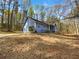 Charming blue home surrounded by lush trees, situated on a landscaped lot at 160 Benjamin Cir, Fayetteville, GA 30214