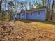 Ranch home with blue siding nestled on a wooded lot at 160 Benjamin Cir, Fayetteville, GA 30214