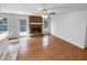 Open-concept living room with hardwood floors and a brick fireplace at 160 Benjamin Cir, Fayetteville, GA 30214