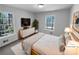Cozy main bedroom with neutral tones and large windows offering wooded views at 160 Benjamin Cir, Fayetteville, GA 30214