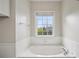 Bright bathroom showcasing a soaking tub and large window at 4100 Paces Se Walk # 2309, Atlanta, GA 30339
