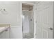 Bathroom featuring tiled shower with glass door and white cabinets at 4100 Paces Se Walk # 2309, Atlanta, GA 30339