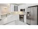 Bright kitchen with white cabinetry, stainless steel appliances and tile backsplash at 4100 Paces Se Walk # 2309, Atlanta, GA 30339