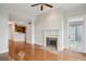 Open-concept living room with hardwood floors, fireplace, and access to a balcony offering an inviting and functional layout at 4100 Paces Se Walk # 2309, Atlanta, GA 30339
