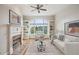 Bright, virtually staged living room with fireplace, built-in shelves, and a large window creating a comfortable atmosphere at 4100 Paces Se Walk # 2309, Atlanta, GA 30339