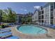 Community outdoor pool surrounded by lounge chairs and lush landscaping at 4100 Paces Se Walk # 2309, Atlanta, GA 30339