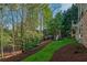 Large backyard view with a playhouse and mature landscaping, and garden at 6186 Talmadge Nw Run, Acworth, GA 30101