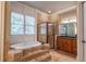 Well-appointed bathroom with a large tub, shower, and plenty of natural light at 6186 Talmadge Nw Run, Acworth, GA 30101