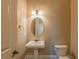 Charming powder room features pedestal sink, decorative lighting and neutral color palette at 6186 Talmadge Nw Run, Acworth, GA 30101