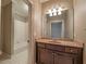 This bathroom includes a vanity with cabinets and a bathtub with white tiles at 6186 Talmadge Nw Run, Acworth, GA 30101