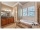 Bright bathroom with a soaking tub, walk-in shower, and granite countertop vanity at 6186 Talmadge Nw Run, Acworth, GA 30101
