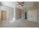 Large bedroom with a ceiling fan, neutral colors, and walk-in closet at 6186 Talmadge Nw Run, Acworth, GA 30101
