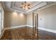 Bedroom features hardwood flooring, tray ceilings, and ample natural light at 6186 Talmadge Nw Run, Acworth, GA 30101