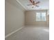 Spacious bedroom featuring carpet, a ceiling fan, and a large window at 6186 Talmadge Nw Run, Acworth, GA 30101
