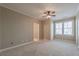 Neutral bedroom featuring carpet flooring and large windows at 6186 Talmadge Nw Run, Acworth, GA 30101