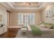 Stylishly staged bedroom features tray ceilings, hardwood floors, and access to a private balcony at 6186 Talmadge Nw Run, Acworth, GA 30101