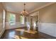 Bright dining room with a classic chandelier, wainscoting, and large windows at 6186 Talmadge Nw Run, Acworth, GA 30101