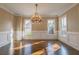 Sun-drenched dining room with decorative chandelier, beautiful trimwork, and hardwood flooring at 6186 Talmadge Nw Run, Acworth, GA 30101