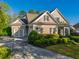 Beautiful single-story home with a large driveway and manicured landscaping at 6186 Talmadge Nw Run, Acworth, GA 30101