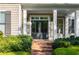 Inviting front entrance with brick steps, columns, and a stylish double door entry at 6186 Talmadge Nw Run, Acworth, GA 30101