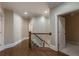 Hallway features wood floors and an open staircase at 6186 Talmadge Nw Run, Acworth, GA 30101