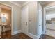 Hallway view with access to a bathroom, closet and laundry area, with neutral paint at 6186 Talmadge Nw Run, Acworth, GA 30101