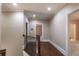 Second-floor hallway with wood flooring and two doorways at 6186 Talmadge Nw Run, Acworth, GA 30101