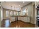 Bright eat-in kitchen features stainless appliances, granite counters, hardwood floors and pendant lighting at 6186 Talmadge Nw Run, Acworth, GA 30101