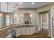 Gourmet kitchen with granite countertops and modern lighting at 6186 Talmadge Nw Run, Acworth, GA 30101
