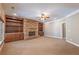 Cozy living room featuring a stone fireplace, custom built-ins, and ample space for relaxation at 6186 Talmadge Nw Run, Acworth, GA 30101