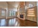 Spacious living room features brick fireplace, hardwood floors, built-in shelving and plenty of natural light at 6186 Talmadge Nw Run, Acworth, GA 30101