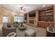 Staged living room with a fireplace, sofa, ottoman, and decor highlighting the room's cozy appeal at 6186 Talmadge Nw Run, Acworth, GA 30101