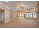 Spacious living room showcasing a stone fireplace, large windows, and neutral color palette at 6186 Talmadge Nw Run, Acworth, GA 30101