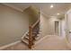Carpeted staircase with stained wood railing and white trim leading to the next level of the home at 6186 Talmadge Nw Run, Acworth, GA 30101