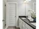 Bright bathroom features a double vanity with black countertop and white cabinetry at 709 Bismark Ne Rd, Atlanta, GA 30324