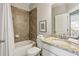 This bathroom features a shower/bath combo with marble counter tops at 709 Bismark Ne Rd, Atlanta, GA 30324