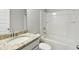 Clean bathroom with a shower-tub combo and a vanity featuring a granite countertop at 709 Bismark Ne Rd, Atlanta, GA 30324