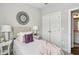 Cozy bedroom with a circular mirror on the wall and ensuite bath at 709 Bismark Ne Rd, Atlanta, GA 30324
