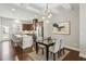 Modern kitchen with stainless steel appliances, a breakfast bar, and a dining area with stylish light fixture at 709 Bismark Ne Rd, Atlanta, GA 30324